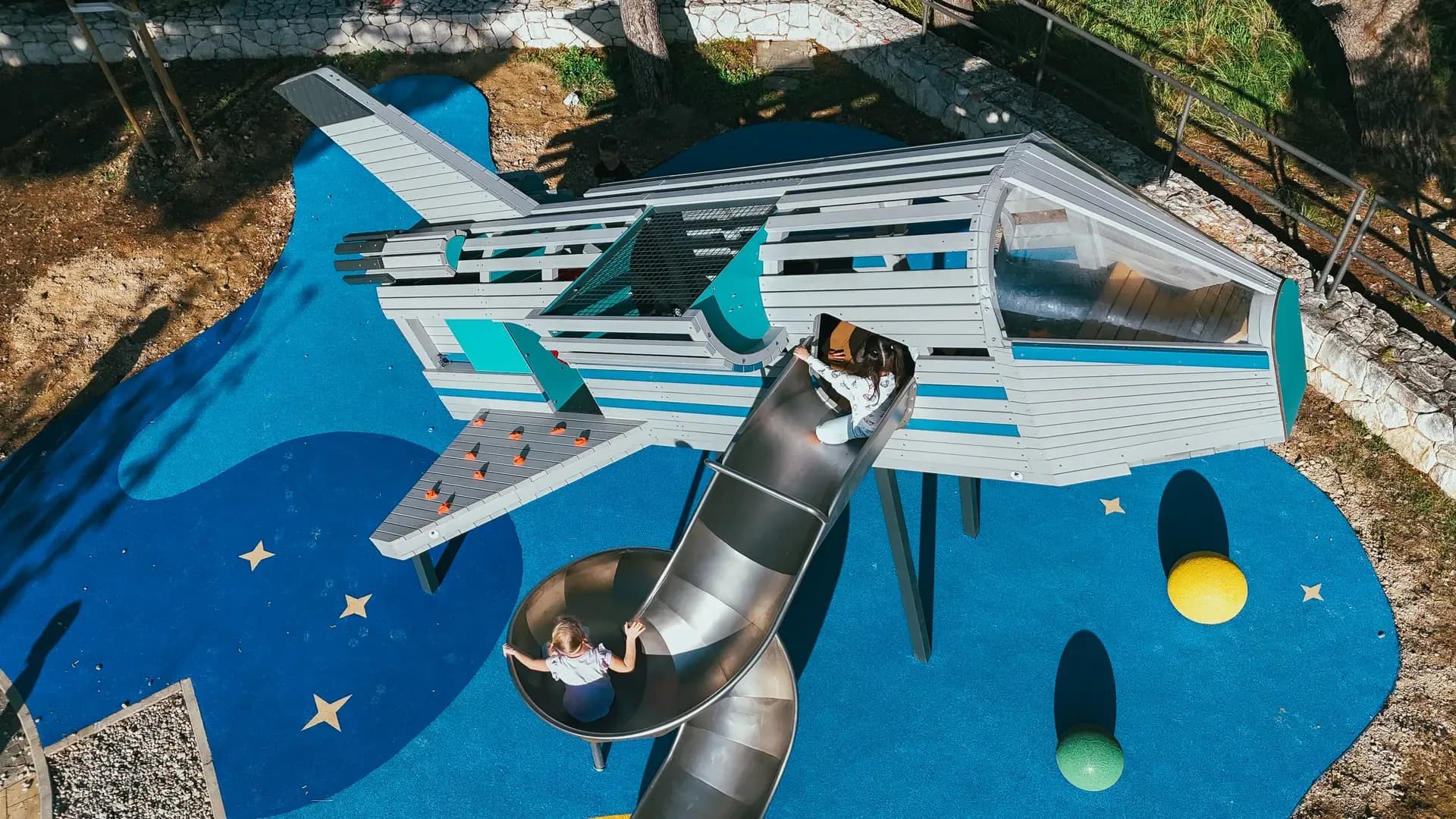 Aerial view of the rocket structure at Makarska Observatory, showing the climbing wall and spiral slide.