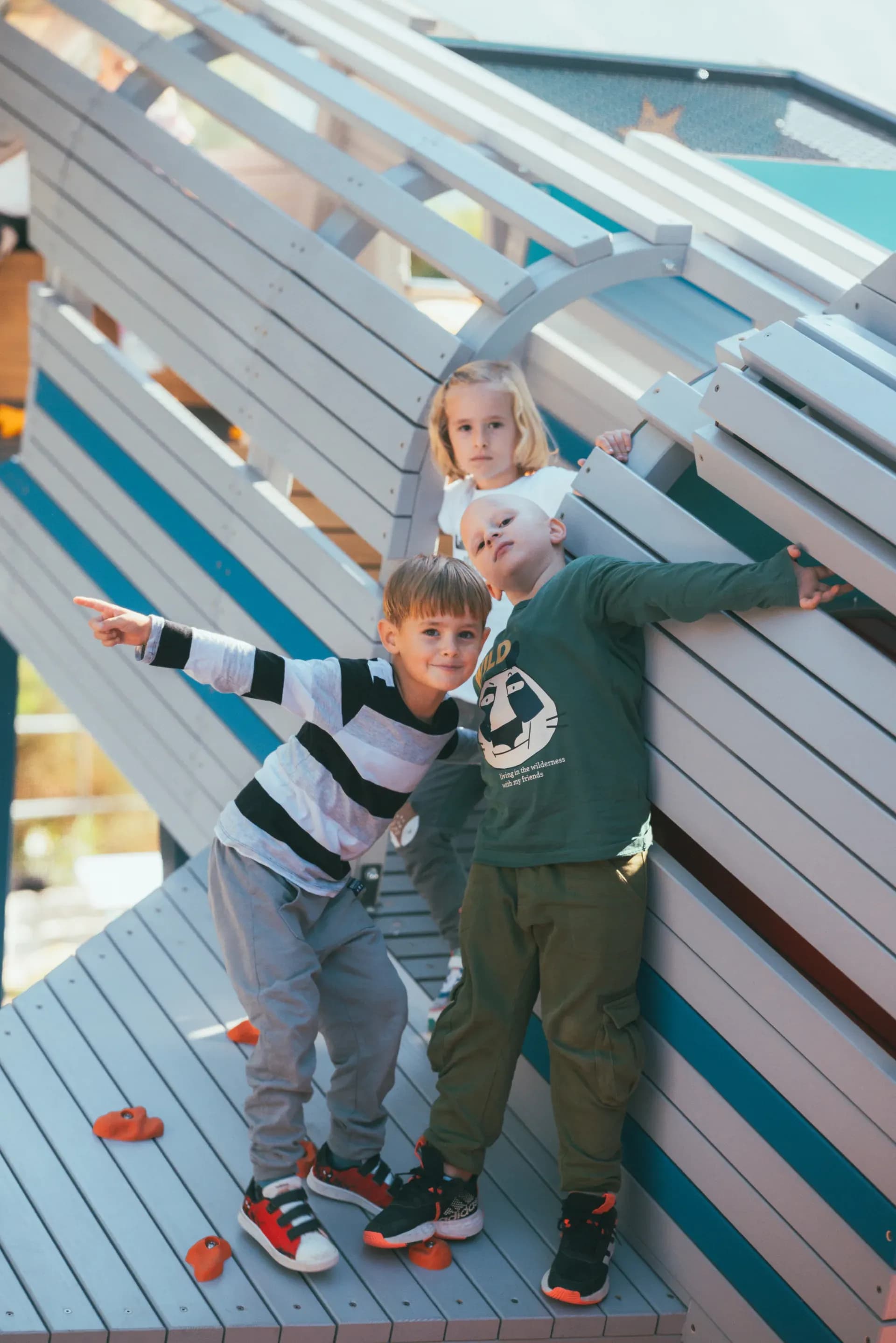 Children at the top platform of the rocket structure at Makarska Observatory, one of them pointing out toward the view.