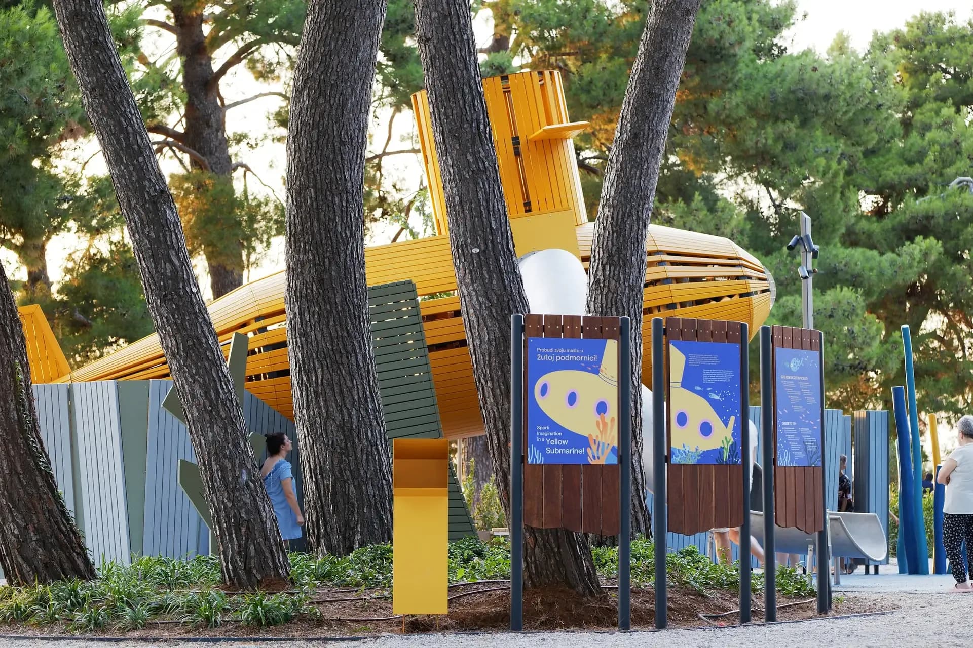 Information panels beside the playground in Croatian and English, the submarine behind them