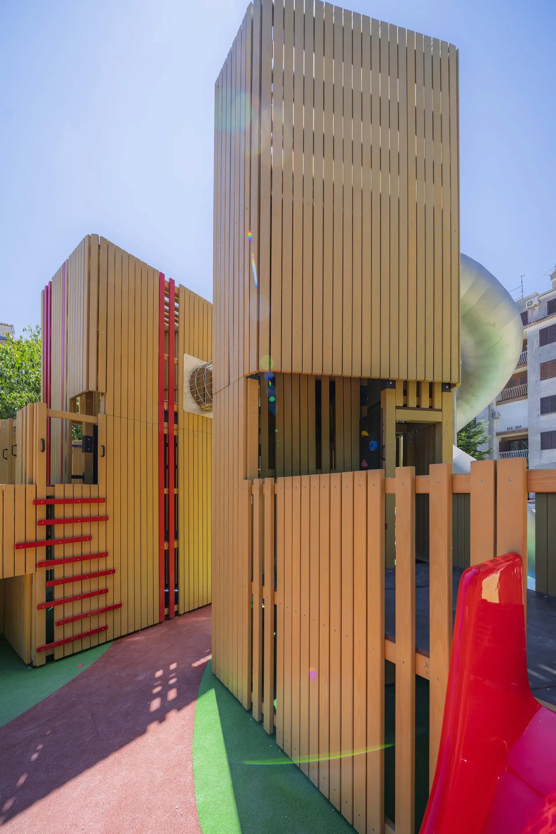 Detail of the red colour accents and tube slide entrance on the Urban Structure playground in Trogir.