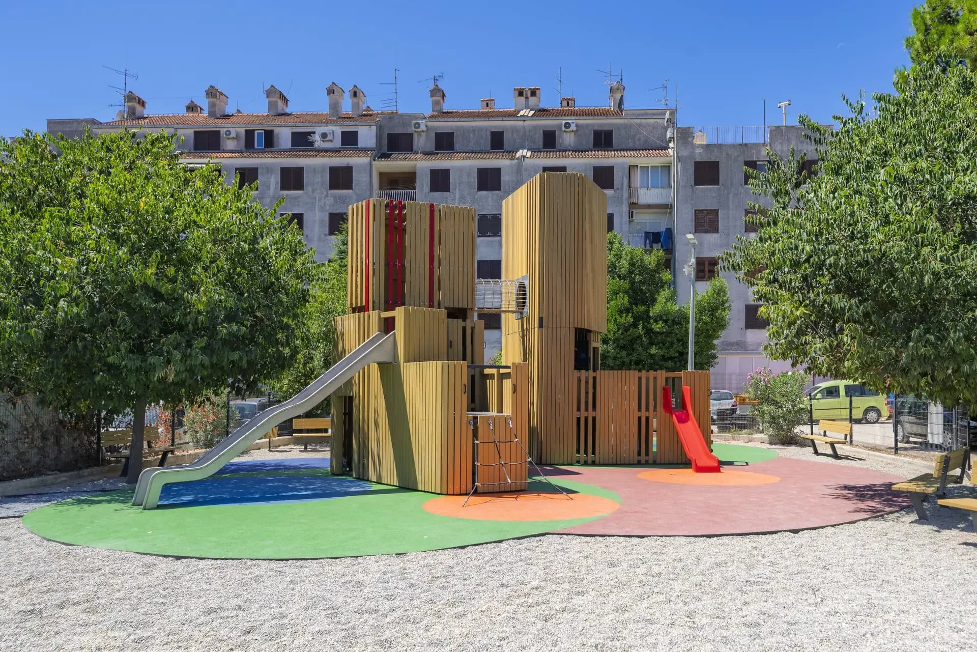 The Urban Structure playground in Trogir, with the residential rooftops that inspired its colour accents visible behind it.