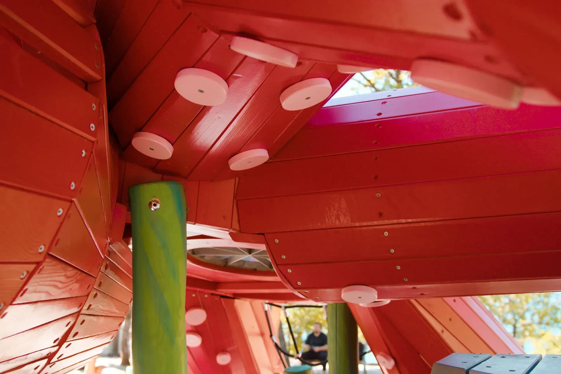 Light filtering through the timber slats inside the octopus structure at Glavotok.