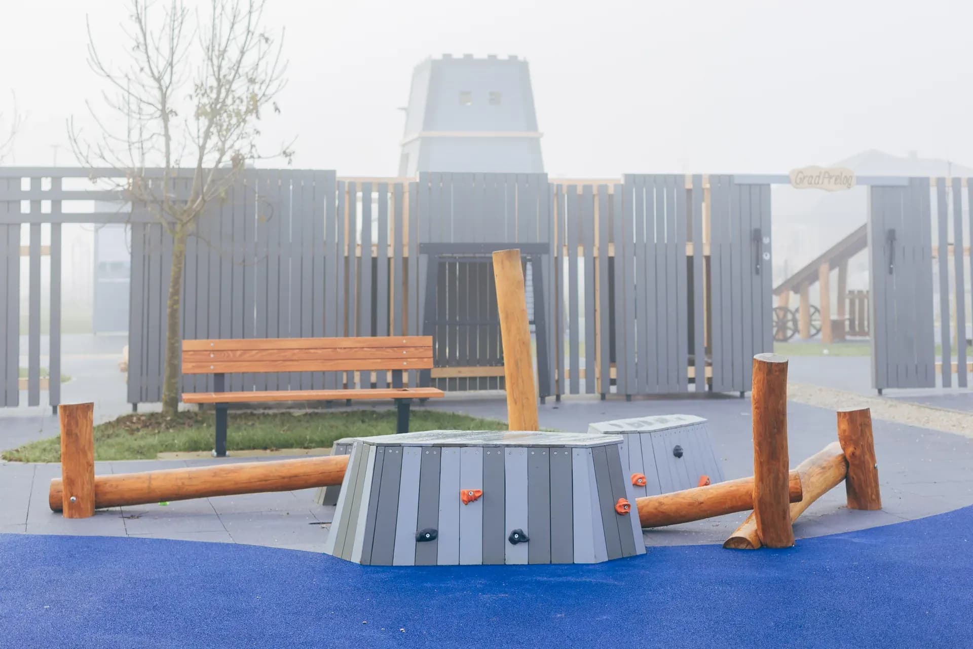 Log balance beams and climbing blocks outside the Timeless Legends tower.