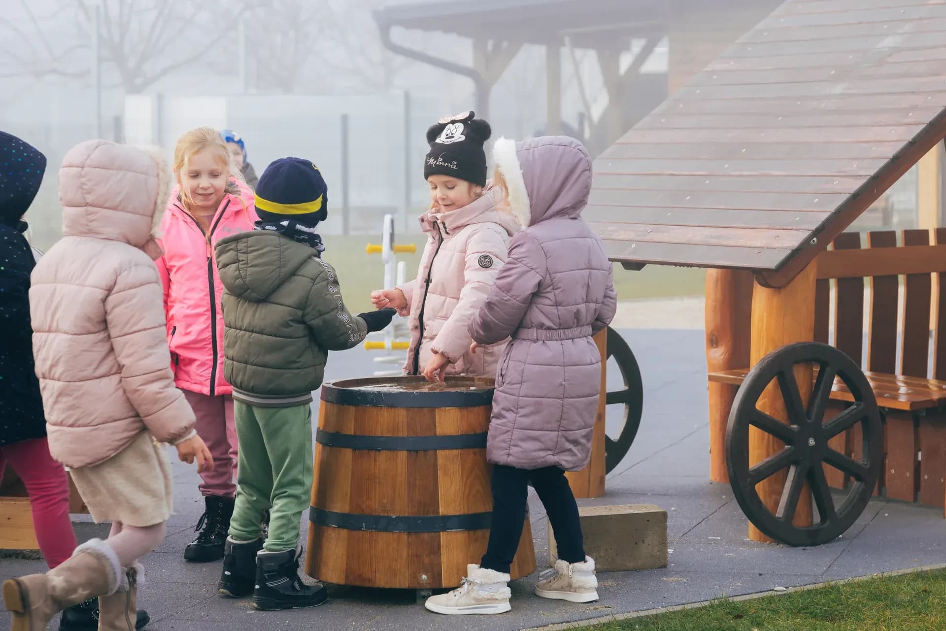 Children gathered around the market barrel at Timeless Legends.